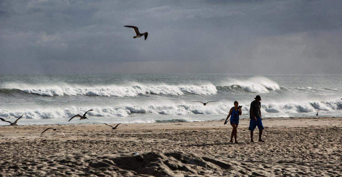 Beachgoers take in the scenery on Atlantic Beach as Hurricane Florence threatens the Carolinas Wednesday afternoon.