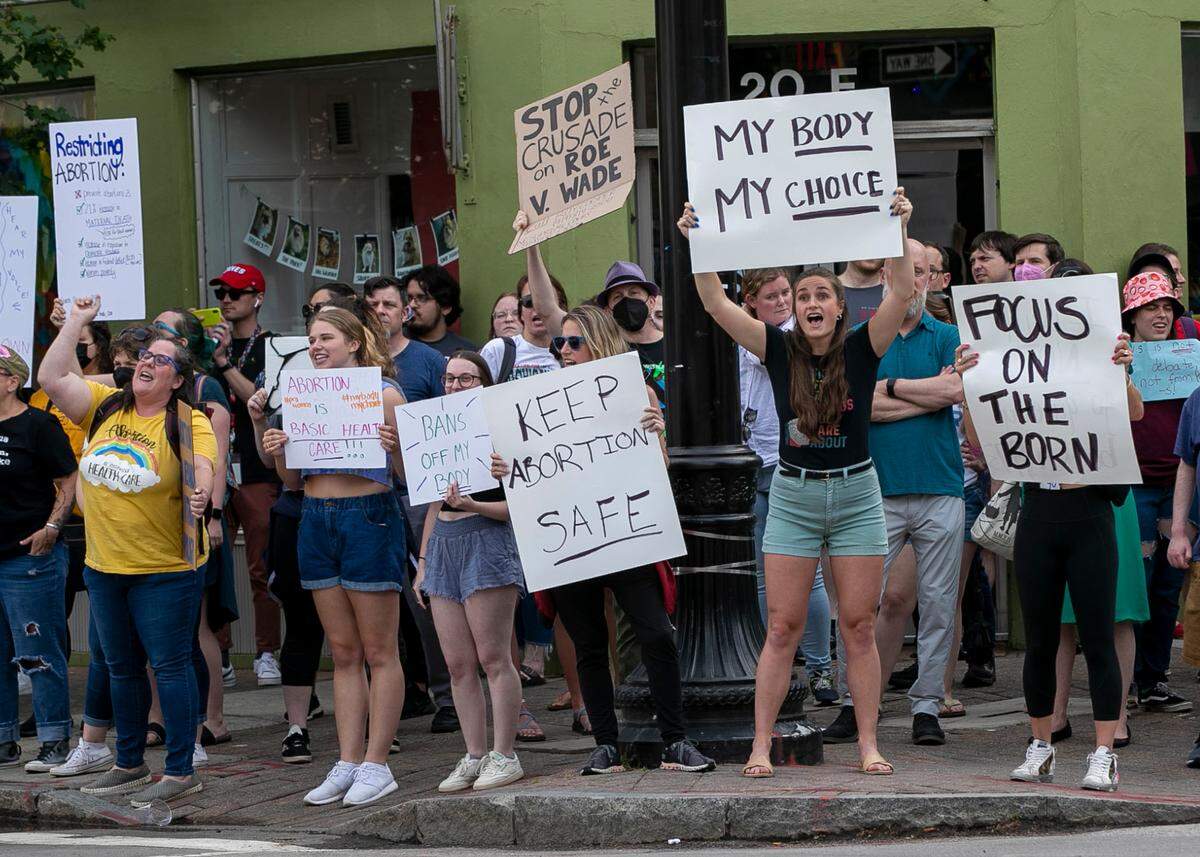 Demonstrators calling for the preservation of abortion rights, react to a draft ruling from the U.S. Supreme Court, that could overturn Roe v. Wade, by gathering on the corner of Hargett and Wilmington Street on Tuesday, May 3, 2022 in Raleigh, N.C.