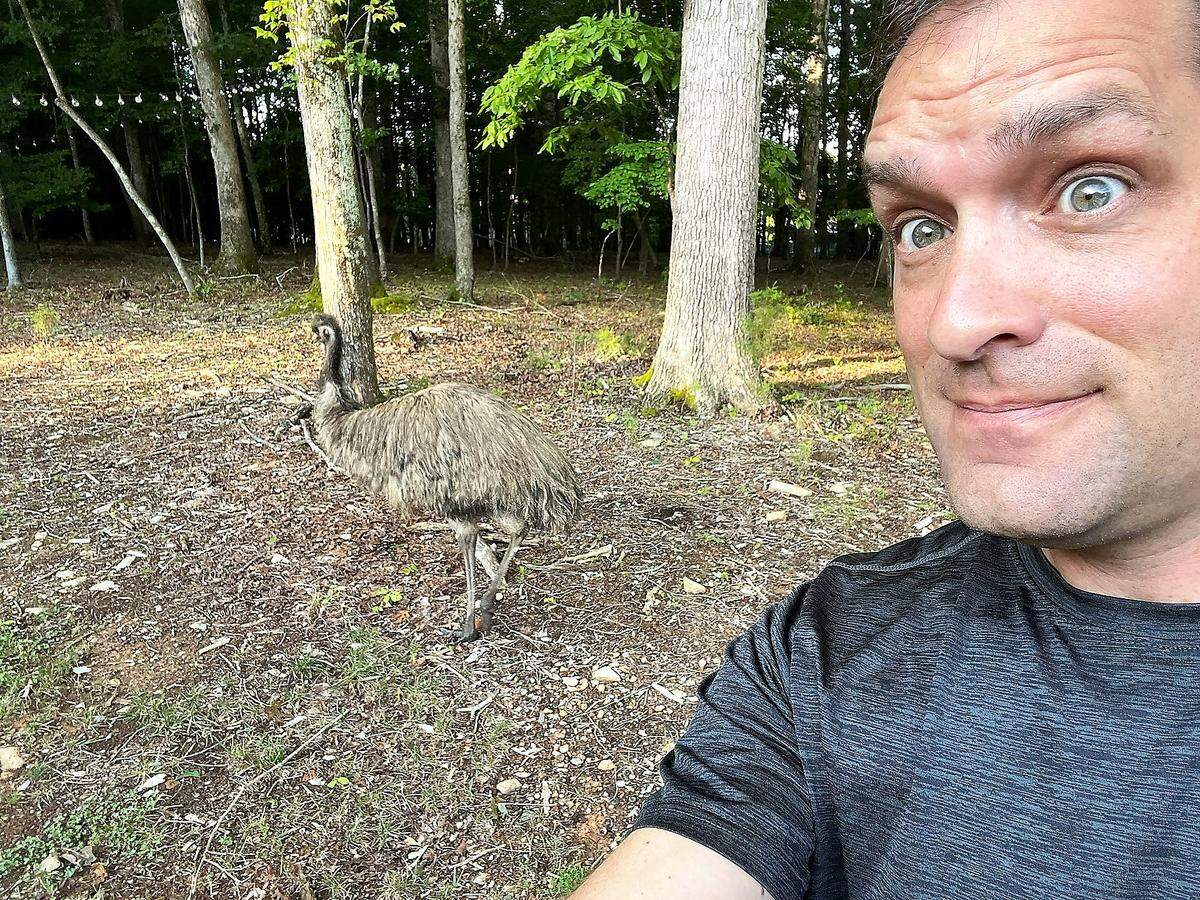 State Sen. Graig Meyer mugs for the camera after finding Biggie the emu in his back yard north of Chapel Hill. The emu stayed on the run for more than 24 hours, until a neighborhood network tracked him down.