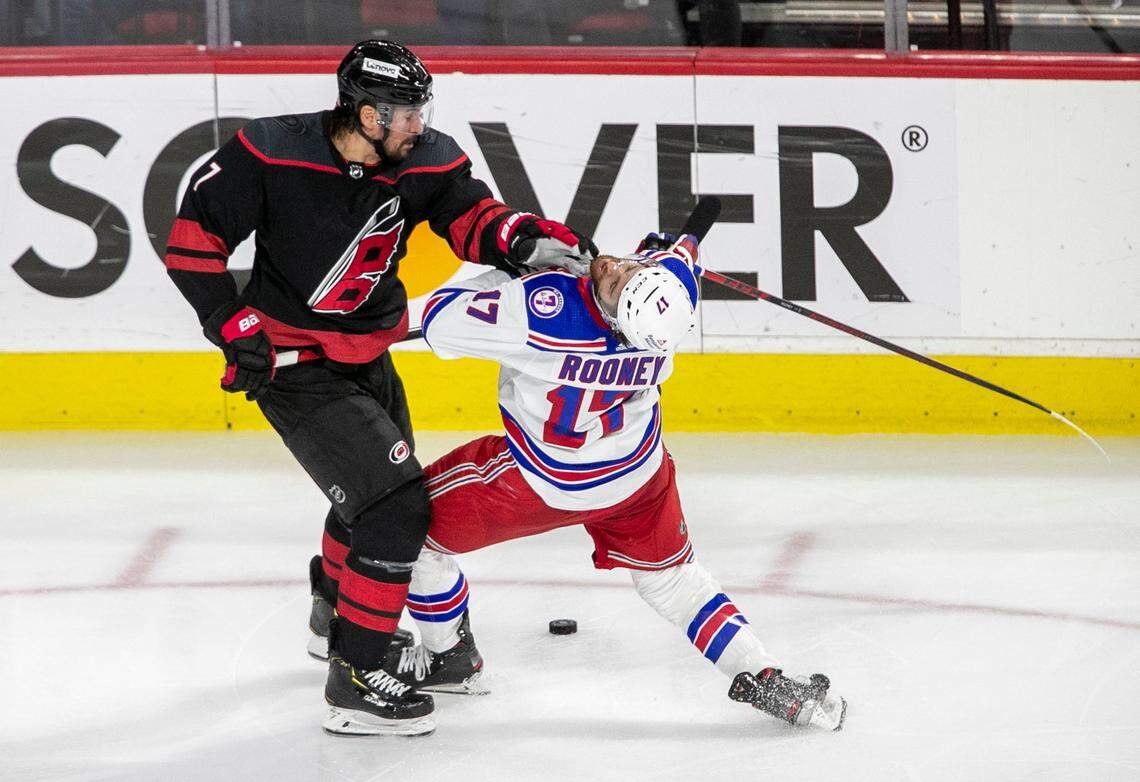 Carolina Hurricanes Brendan Smith (7) checks New York Rangers Kevin Rooney (17) during the second period on Thursday, May 26, 2022 during game five of the Stanley Cup second round at PNC Arena in Raleigh, N.C.