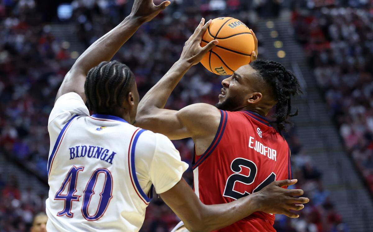 Zuby Ejiofor #24 of the St. John's Red Storm is defended by Flory Bidunga #40 of the Kansas Jayhawks in the second round of the 2026 NCAA Men's Basketball Tournament at Viejas Arena at San Diego State University on March 22, 2026
