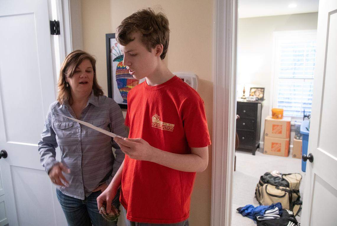 Joe Branan, 18, and his mother Laura Branan review a step-by-step picture guide showing Joe how exactly to take a shower Tuesday, Feb. 11, 2020 at their Chapel Hill home. Joe was diagnosed with autism at age 2 and his parents have been on the waitlist for an Innovations Waiver for 16 years. The Innovations Waiver is a Medicaid program that was enacted statewide in 2013 to offer home and community based services (HCBS) to people with intellectual and/or developmental disabilities as an alternative to institutionalized care.