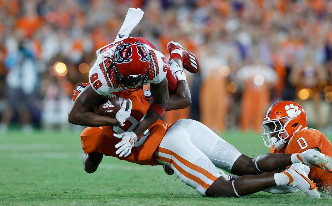 N.C. State wide receiver Devin Carter (88) is tackled by Clemson safety R.J. Mickens (9) during the second half of Clemson’s 30-20 victory over N.C. State at Memorial Stadium in Clemson, S.C., Saturday, Oct. 1, 2022.