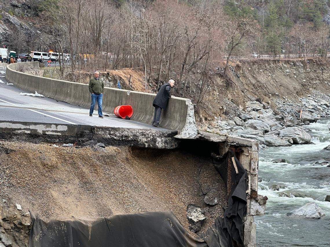 U.S. Sen. Thom Tillis looks into the Pigeon River from what’s left of the eastbound lanes of Interstate 40 in February. Helene’s floodwaters washed out more than a mile of the eastbound lanes of I-40 in the Pigeon River Gorge in the fall of 2024.