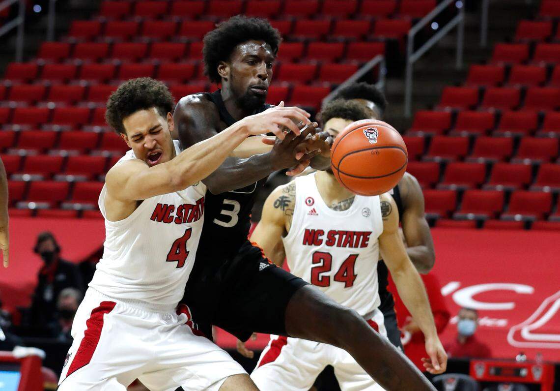 N.C. State’s Jericole Hellems (4) fights for a rebound with Miami’s Nysier Brooks (3) during the second half of Miami’s 64-59 victory over N.C. State at PNC Arena in Raleigh, N.C., Saturday, January 9, 2021.