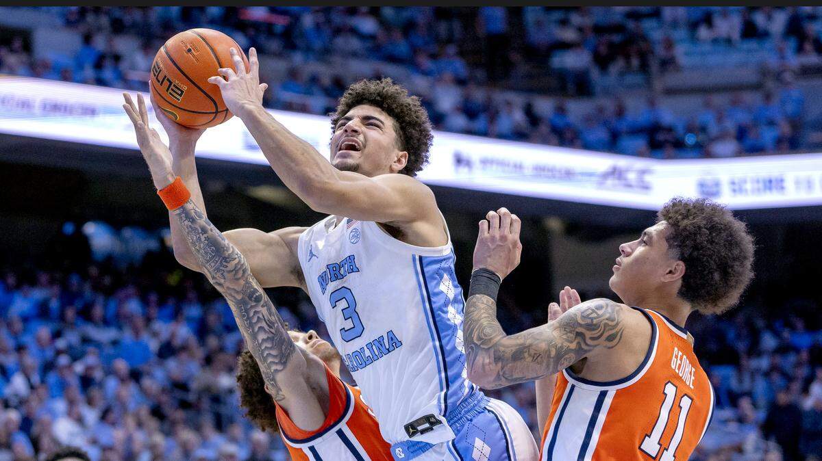 North Carolina guard Derek Dixon (3) drives to the basket between Syracuse guards Nate Kingz (4) and Nathan George (11) in the first half on Monday, February 2, 2026 at the Smith Center in Chapel Hill, N.C.