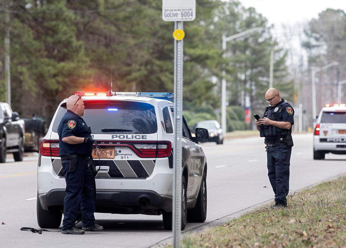 Law enforcement stand near the intersection of NC-55 and Crete Street on Thursday, Feb. 9, 2023, in Durham, N.C.