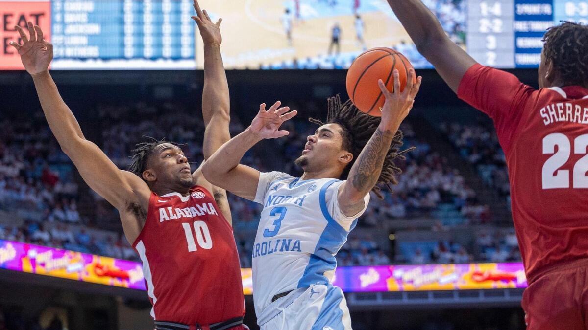 North Carolina guard Elliot Cadeau (3) drives to the basket against Alabama guard Labaron Philon (0) in the first half on Wednesday, December 4, 2024 at the Smith Center in Chapel Hill, N.C.