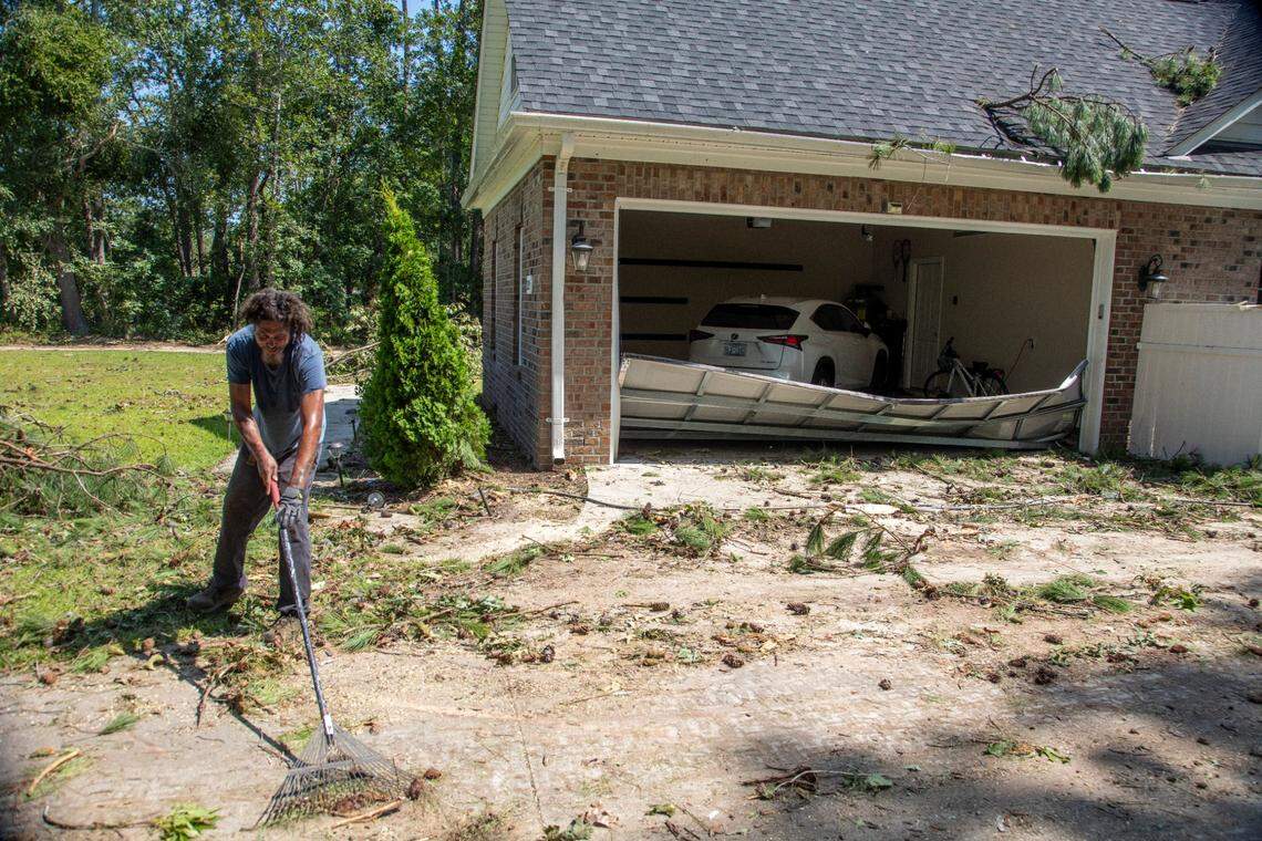 Antonio Middleton of Nashville helps clean up at a damaged home on Great Glen in the Belmont Lakes Country Club community in Rocky Mount Thursday, July 20, 2023. An EF3, tornado with wind speeds of 150 mph touched down in Nash County Wednesday around 12:30 p.m. Wednesday according to the Raleigh National Weather Service..