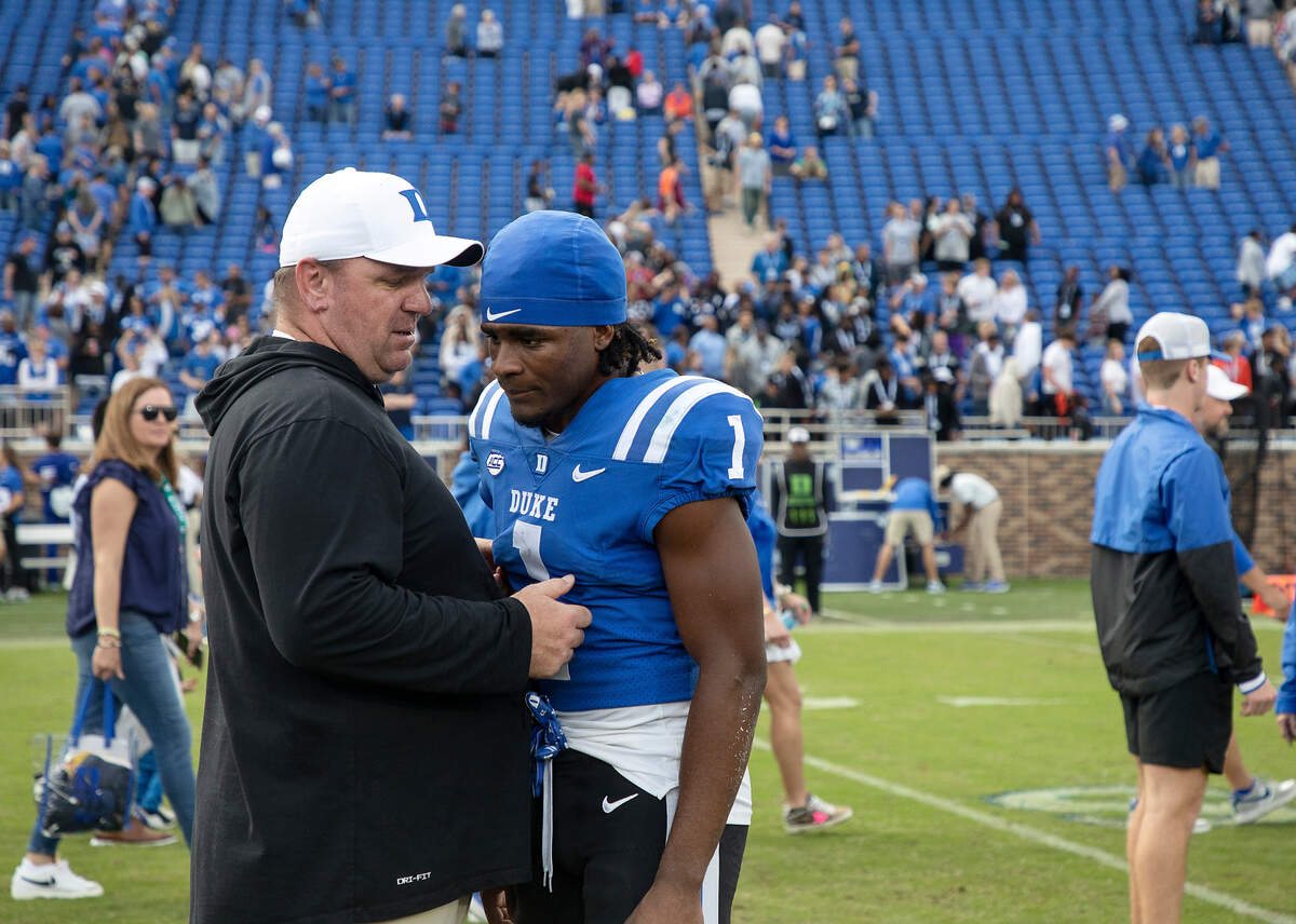 Duke head coach Mike Elko speaks with wide receiver Jontavis Robertson following the Blue Devils’ 24-7 win over Virginia Tech at Wallace Wade Stadium on Saturday, Nov. 12, 2022, in Durham, N.C.