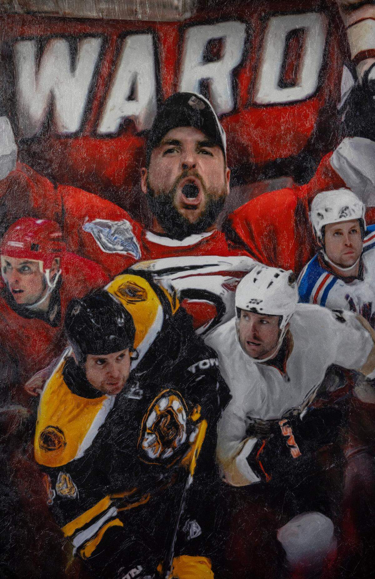 An oil painting of Aaron Ward featuring the NHL teams he played for, hangs in his Apex home on Friday, May 10, 2024. Ward is a three-time Stanley Cup Champion and member of the 2006 Carolina Hurricanes Championship team.