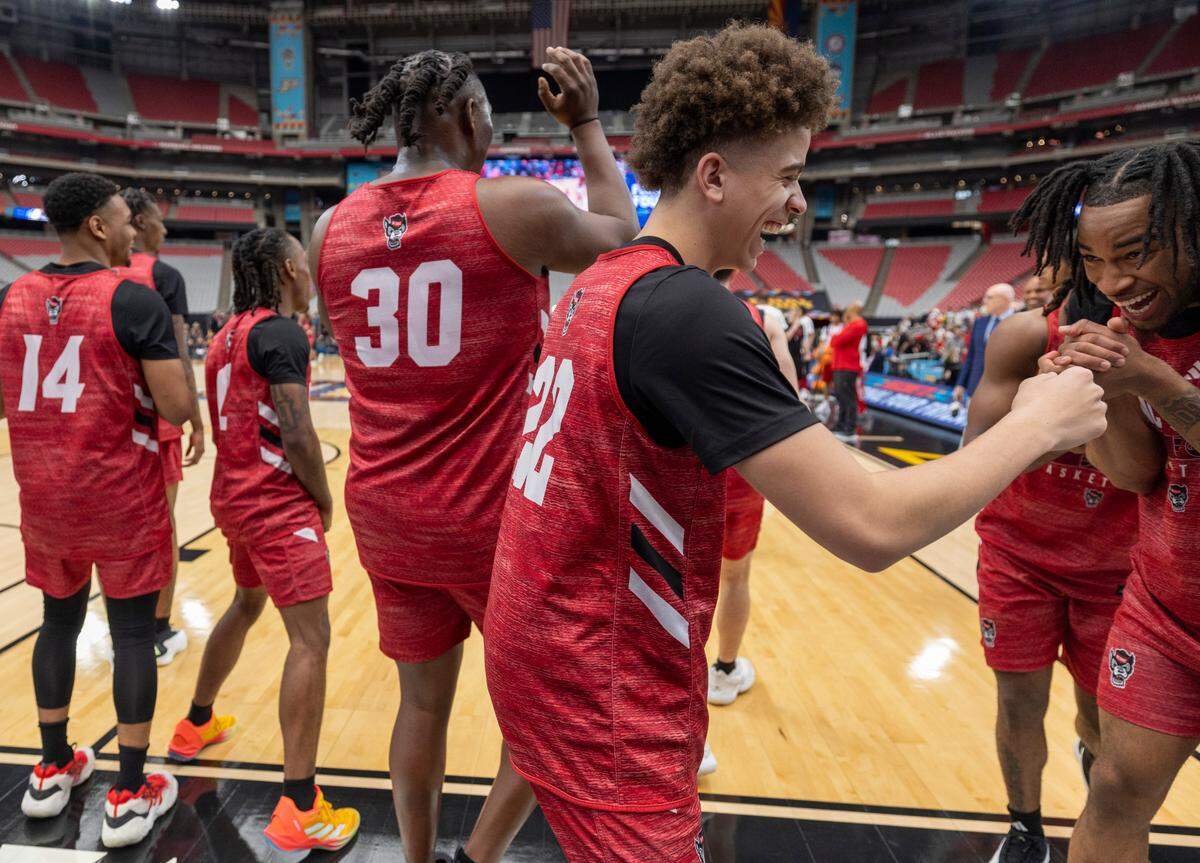 N.C. State’s Jordan Snell (22) laughs with Jayden Taylor (1) during the Wolfpack’s practice on Friday, April 5, 2024, as they prepare for their NCAA National Semi-Final game against Purdue at State Farm Stadium in Glendale, AZ.