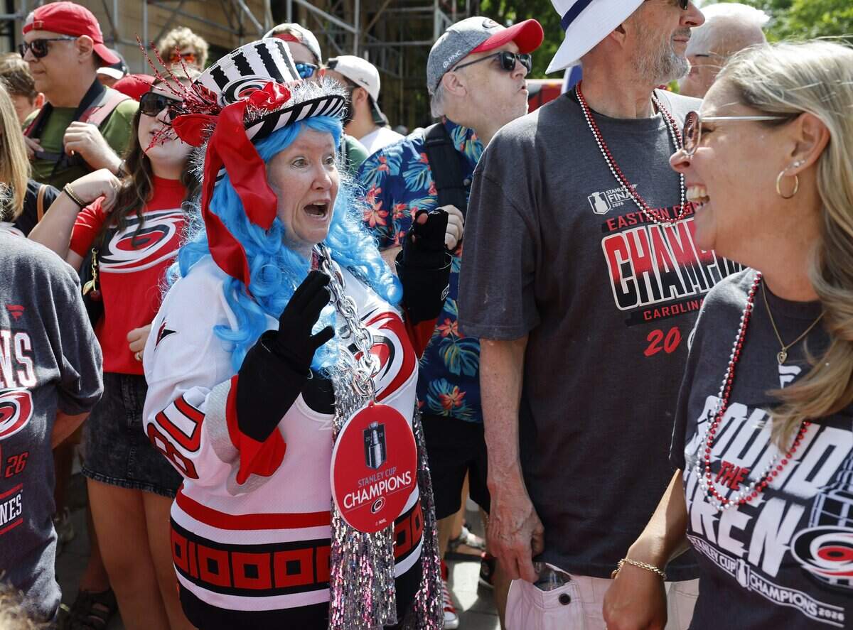 Shelly Hudson-Baker, left, laughs with Ami de Clippelaar before a parade and rally for the Carolina Hurricanes in downtown Raleigh Saturday, June 20, 2026.