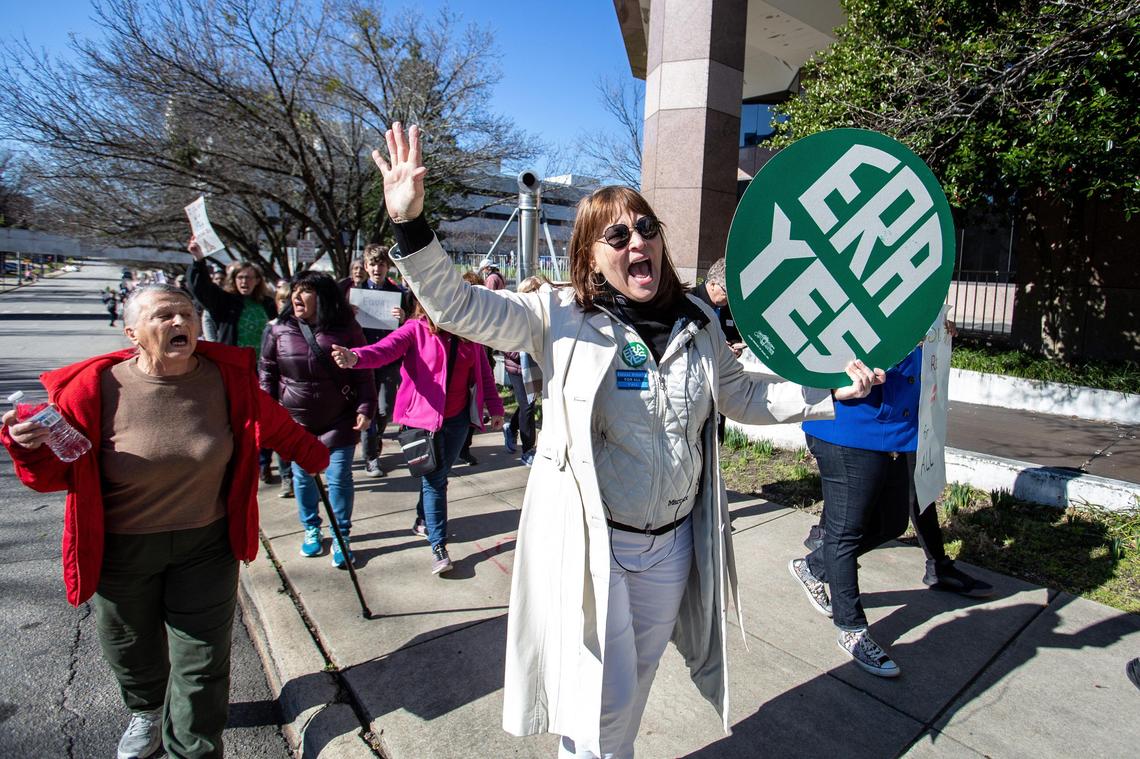 Sherry Macqueen, of Raleigh, holds a sign advocating for the Equal Rights Amendment as she marches during the 2020 Women’s March in Raleigh, N.C., Sunday, Jan. 26, 2020.