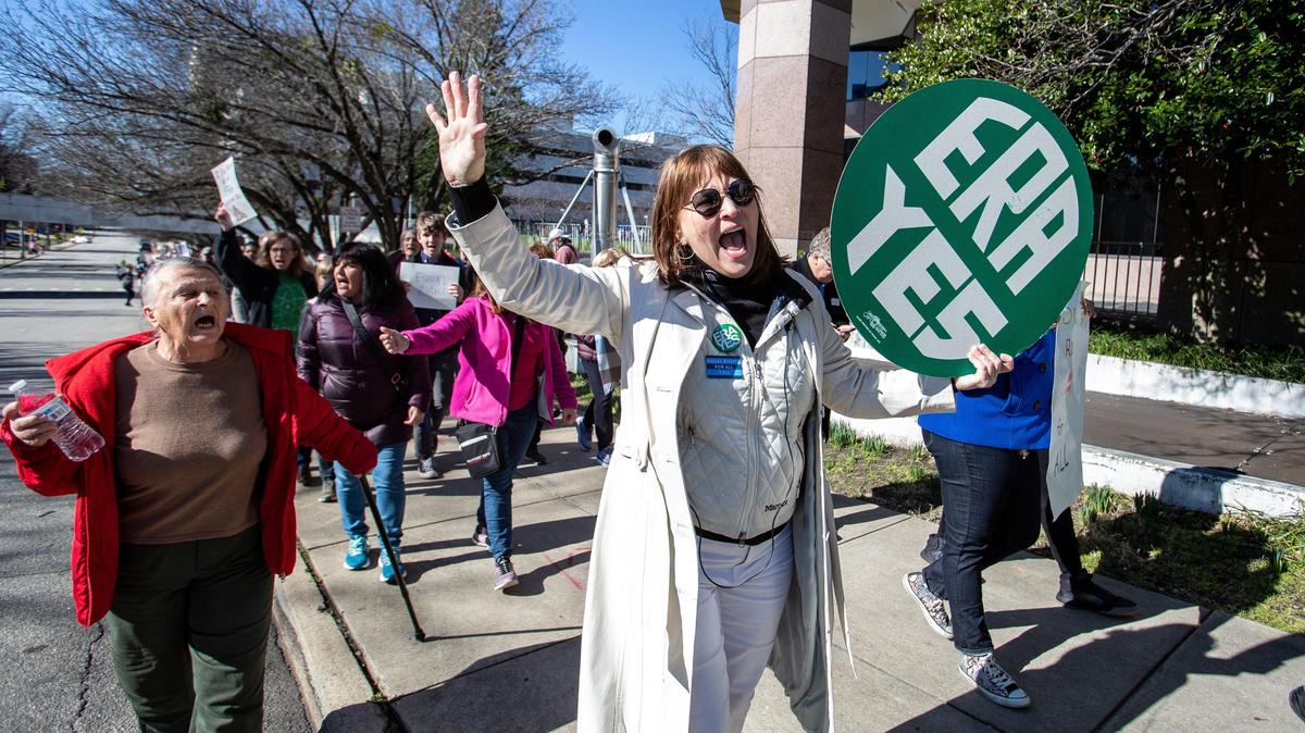 Sherry Macqueen, of Raleigh, holds a sign advocating for the Equal Rights Amendment as she marches during the 2020 Women’s March in Raleigh on Jan. 26, 2020.