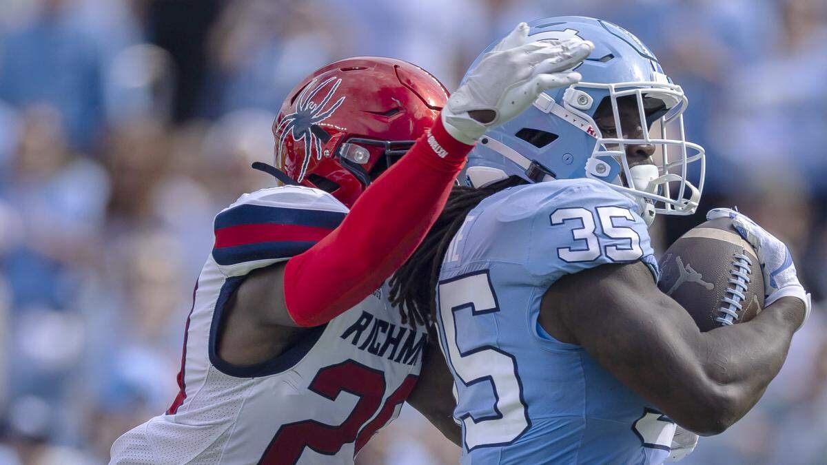 Richmond defensive back C.J. Fraser (29) works to slow North Carolina running back Demon June (35) on a 50-yard gain in the first quarter on Saturday, September 13, 2025 at Kenan Stadium in Chapel Hill, N.C.