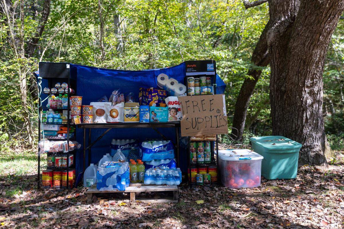 Free relief supplies sit on a creek bank in Cruso on Saturday, October. 5, 2024 after the remnants of Hurricane Helene caused flooding and landslides in the community.