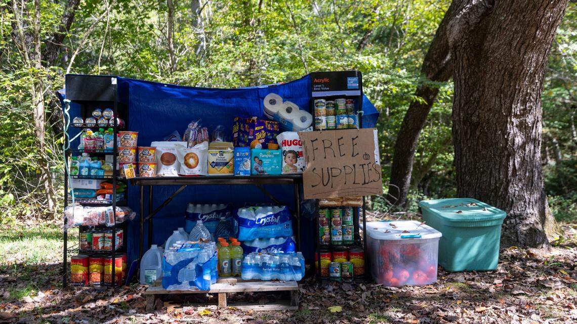 Free relief supplies sit on a creek bank in Cruso on Saturday, Oct. 5, 2024, after the remnants of Hurricane Helene caused flooding and landslides in the community.