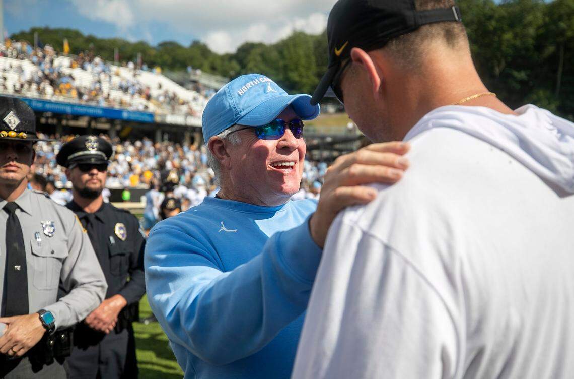 The Appalachian State head coach Shawn Clark congratulates North Carolina coach Mack Brown following the Tar Heels 63-61 victory on Saturday, September 3, 2022 at Kidd Brewer Stadium in Boone, N.C.