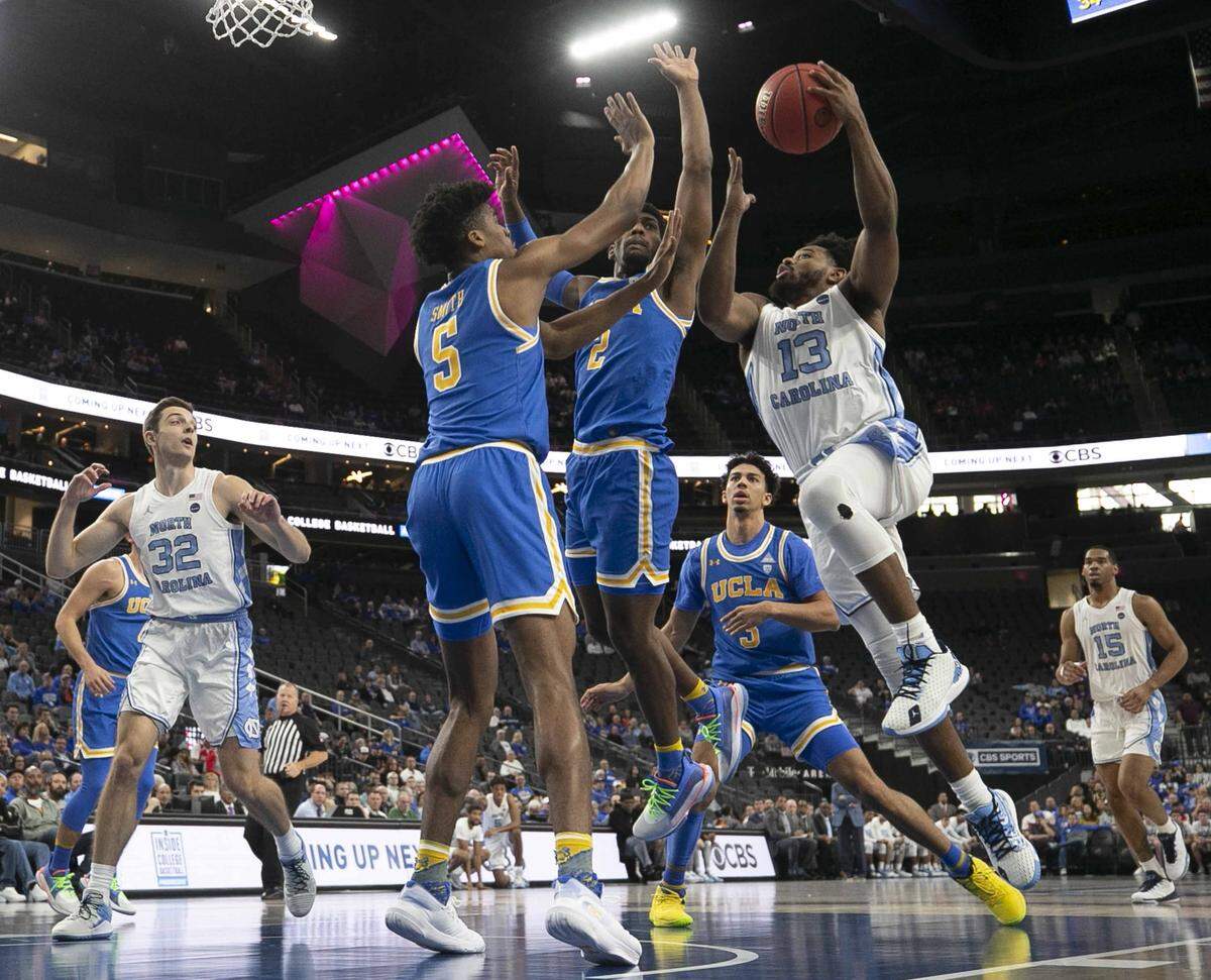 North Carolina’s Jeremiah Francis (13) drives to the basket against UCLA’s Cody Riley (2) and Chris Smith (5) during the first half on Saturday, December 21, 2019 during the CBS Sports Classic at T-Mobile Arena in Las Vegas, Nevada.