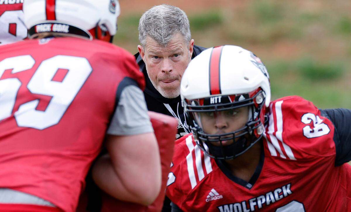 N.C. State offensive line coach Garett Tujague watches N.C. State offensive linemen Jaleel Davis (62) and Dawson Jaramillo (69) run a drill during the Wolfpack’s first spring practice in Raleigh, N.C., Wednesday, March 1, 2023.