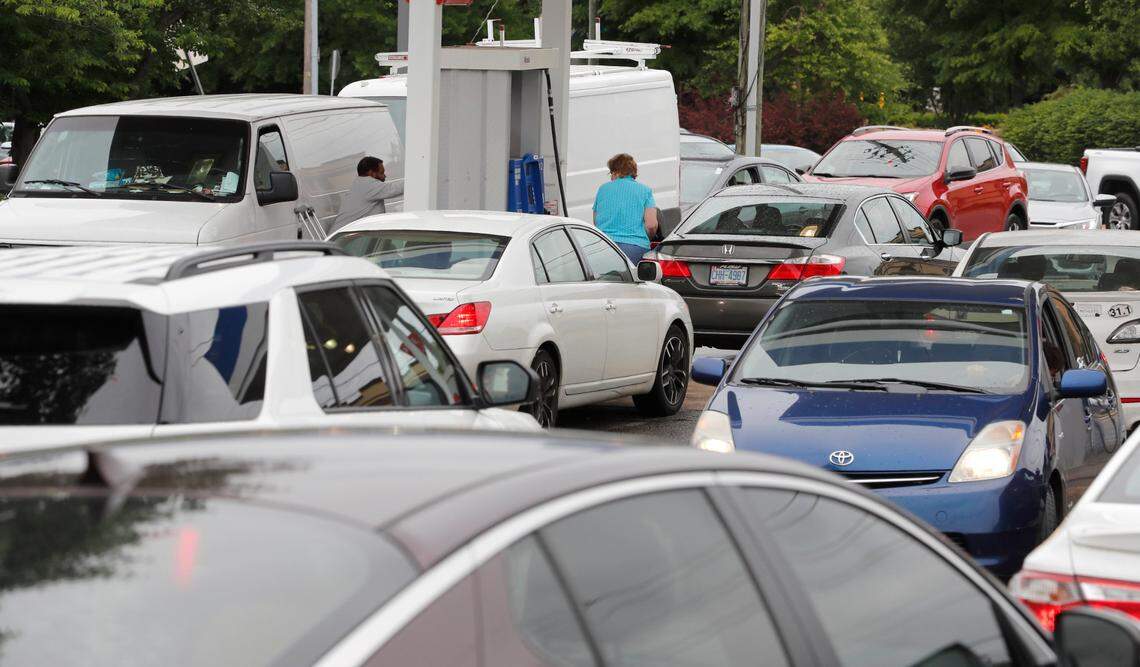 Customers line up for gas at the Mobil station on S. Saunders Street in Raleigh, N.C. Wednesday, May 12, 2021. The station was the only one in the area that had gas available.