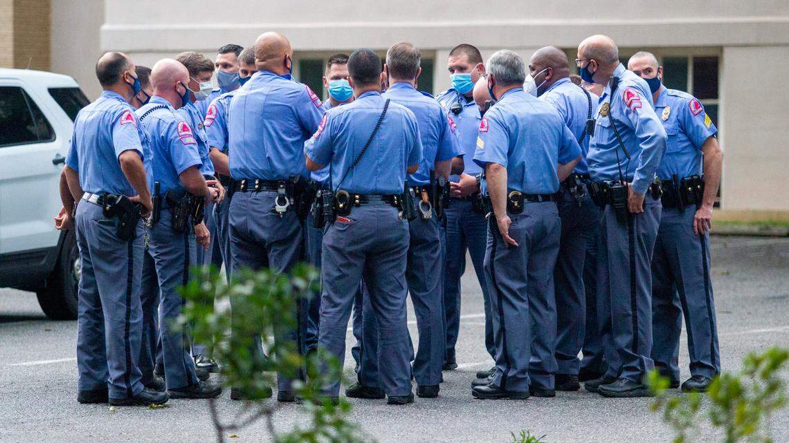 Raleigh Police officers wearing a masks huddle near a protest scene at the North Carolina Confederate Monument on Juneteenth, Friday, June 19, 2020 at the State Capitol.