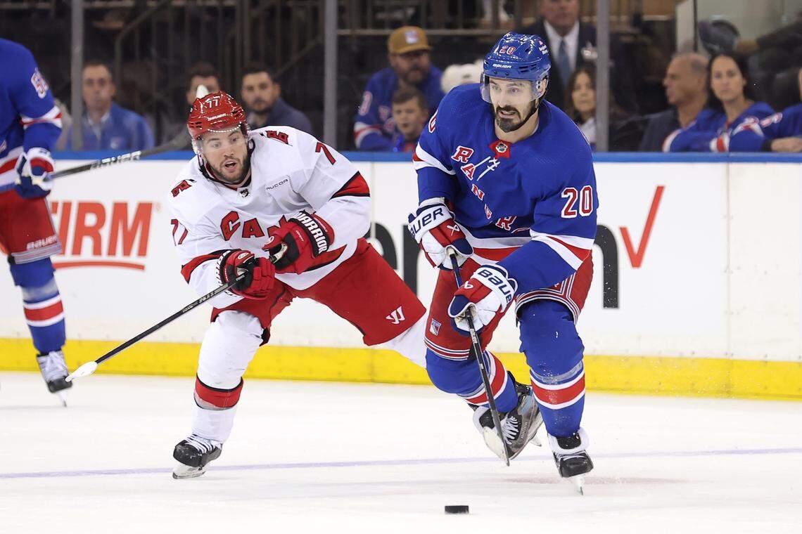 May 7, 2024; New York, New York, USA; New York Rangers left wing Chris Kreider (20) skates with the puck against Carolina Hurricanes defenseman Tony DeAngelo (77) during the third period of game two of the second round of the 2024 Stanley Cup Playoffs at Madison Square Garden. Mandatory Credit: Brad Penner-USA TODAY Sports