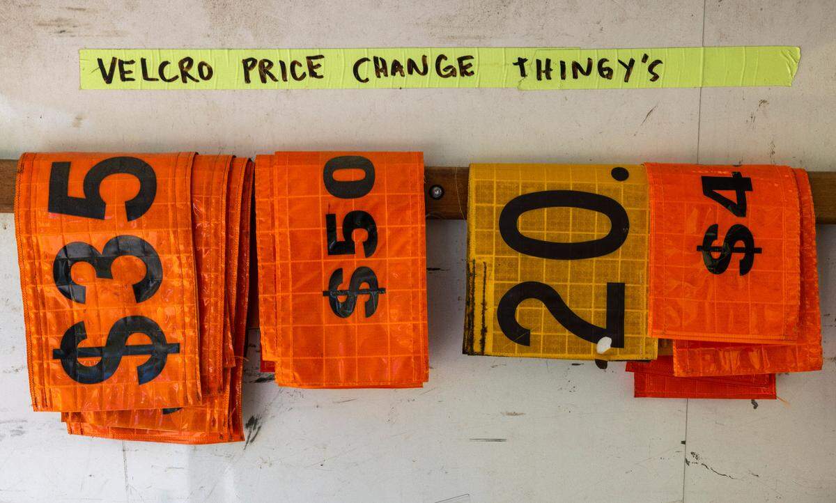A variety of price signs, reflecting the wide range of parking costs for events at Lenovo Center, shown inside of one of the parking and traffic staff vehicles on Tuesday, May 6, 2025 at Lenovo Center in Raleigh, N.C.