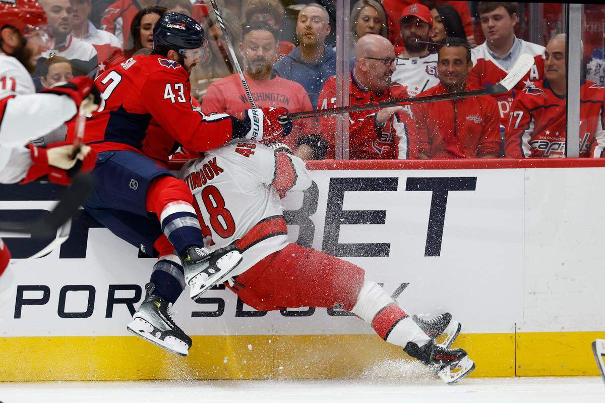 Washington Capitals right wing Tom Wilson (43) c checks Carolina Hurricanes left wing Jordan Martinook (48) in the first period in game two of the second round of the 2025 Stanley Cup Playoffs at Capital One Arena.