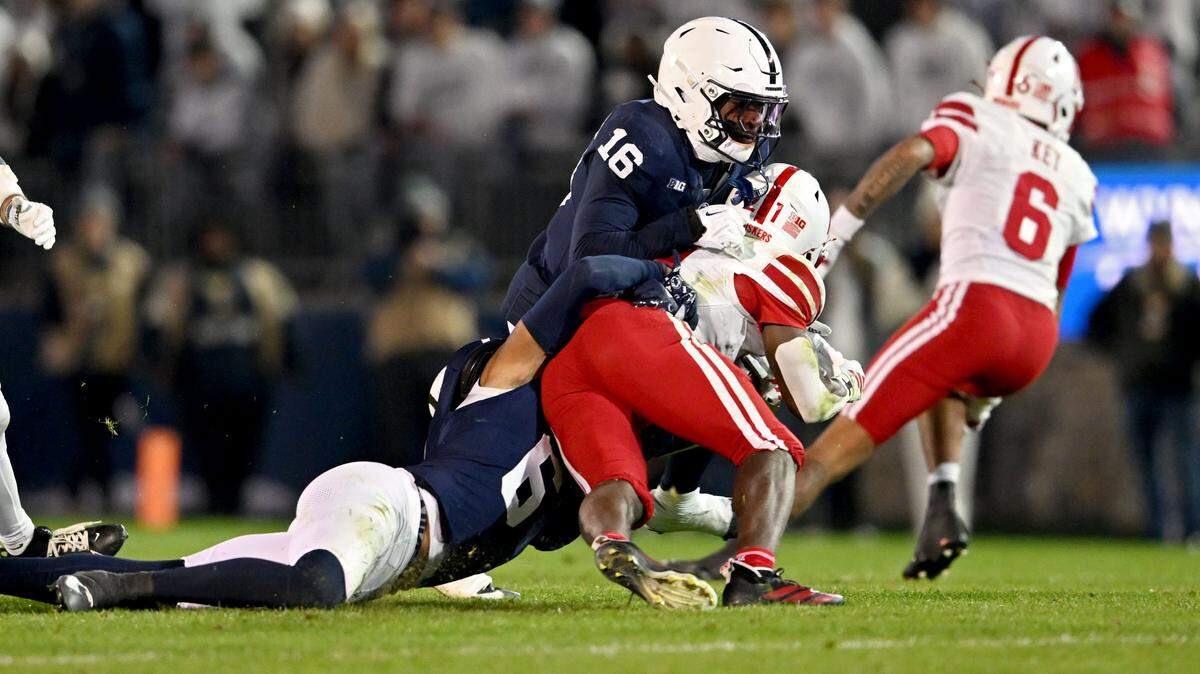 Penn State safeties Zakee Wheatley and King Mack stop Nebraska running back Emmett Johnson during the game on Saturday, Nov. 22, 2025 at Beaver Stadium.