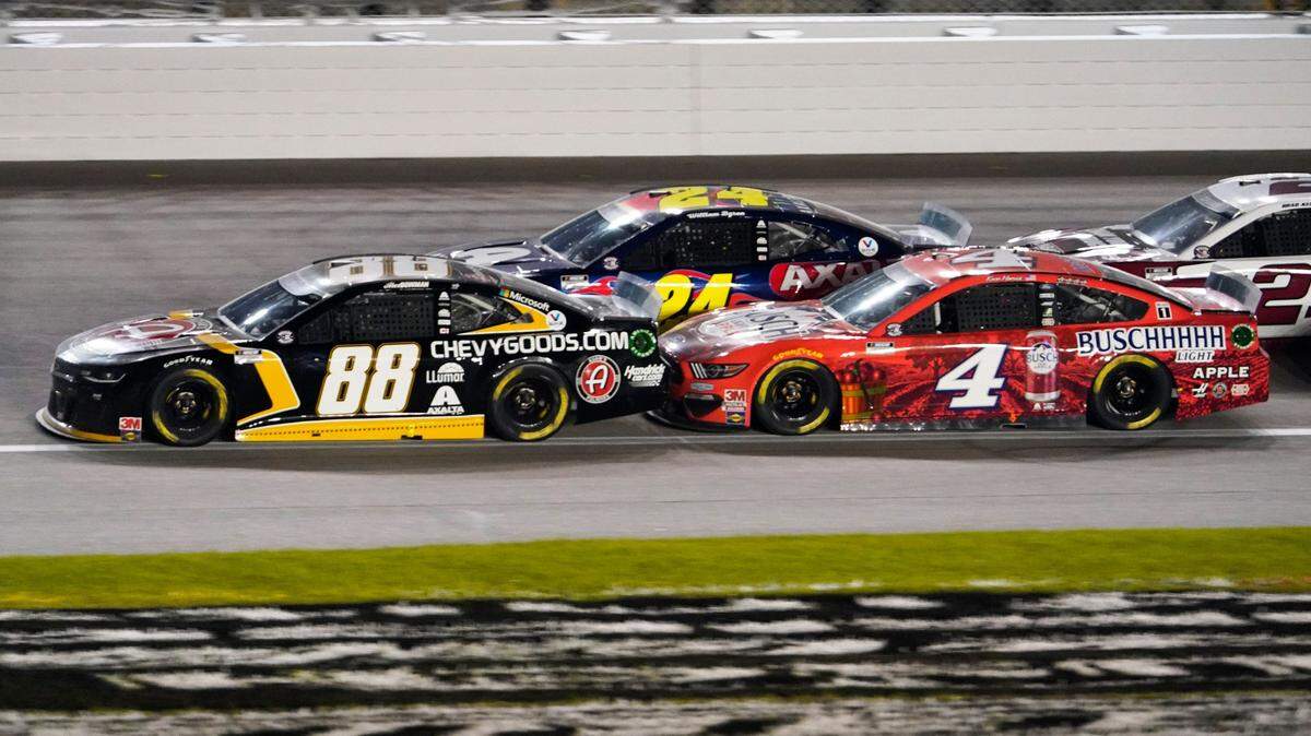 Alex Bowman (88), William Byron (24) and Kevin Harvick (4) battle during a NASCAR Cup Series auto race at Kansas Speedway in Kansas City, Kan., Thursday, July 23, 2020. (AP Photo/Charlie Riedel)