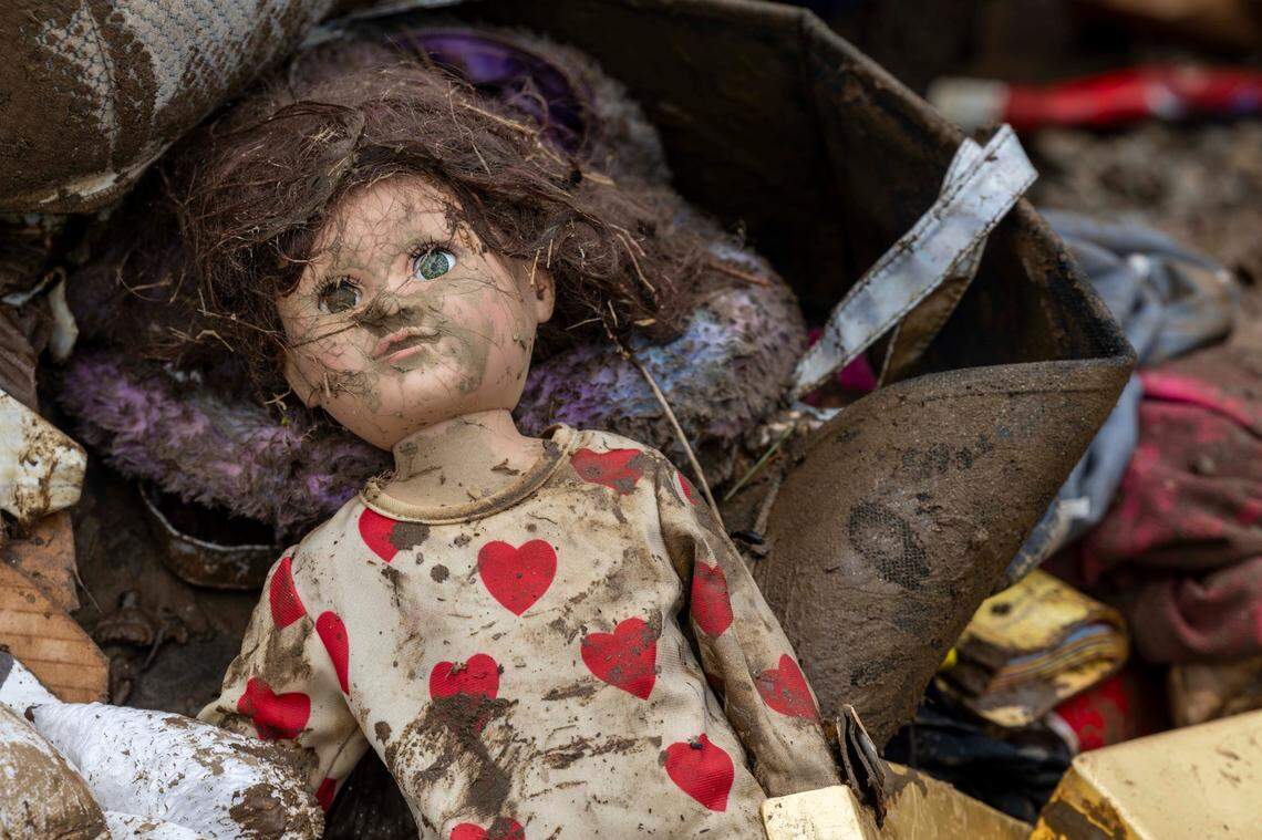 A doll lies in a pile of debris outside a home in Clyde on Saturday, Sept. 28, 2024 as the remnants of Hurricane Helene caused flooding, downed trees, and power outages in western North Carolina.