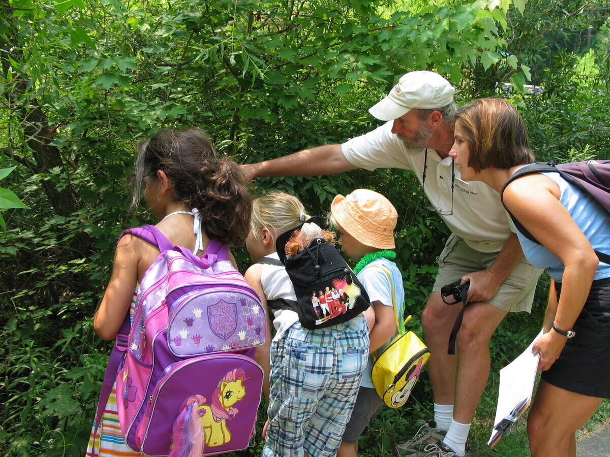 Park naturalist Greg Dodge, known as “Ranger Greg,” shows visitors something fascinating at the Durham Museum of Life and Science.