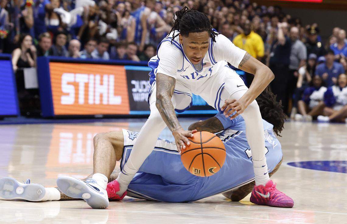 Duke’s Isaiah Evans (3) pulls in the loose ball from North Carolina's Jonathan Powell (11) during the first half of Duke’s game against UNC at Cameron Indoor Stadium in Durham, N.C., Saturday, March 7, 2026.