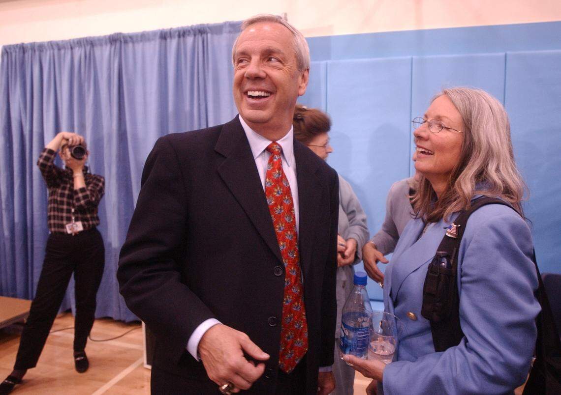 New UNC head basketball coach Roy Williams smiles while standing with his wife Wanda following a press conference announcing Williams’ hiring in the practice gym in the Smith Center, Monday night, April 14, 2003.
