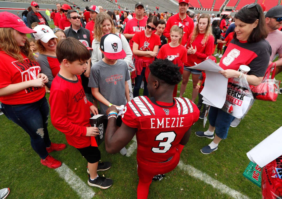 N.C. State wide receiver Emeka Emezie (3) signs autographs for fans after the Kay Yow Spring Football game at Carter-Finley Stadium in Raleigh, N.C., Saturday, April 6, 2019.