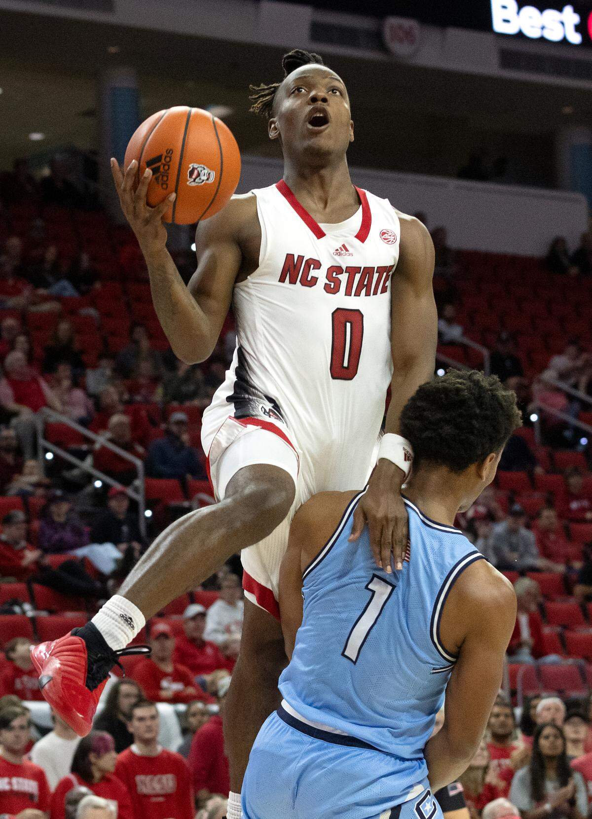 N.C. State’s DJ Horne is fouled by the Citadel’s AJ Smith as he drives to the basket during the second half of the Wolfpack’s season opener on Monday, Nov. 6, 2023, at PNC Arena in Raleigh, N.C.
