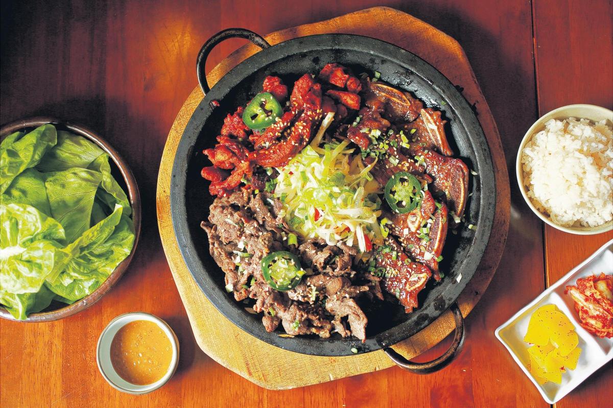 Ssam, a culinary mashup of Korean barbecue and lettuce wraps, is nearly as much fun to assemble as it is to eat at Aroma Korea. Served with a side of rice and a small dish of seasoned soybean paste, ssam is offered with your choice of four meats: bulgogi, galbi, dak galbi or samgyupsal. Better still, round up a friend or two and spring for the BBQ set, pictured here, which gets you any three of the four.