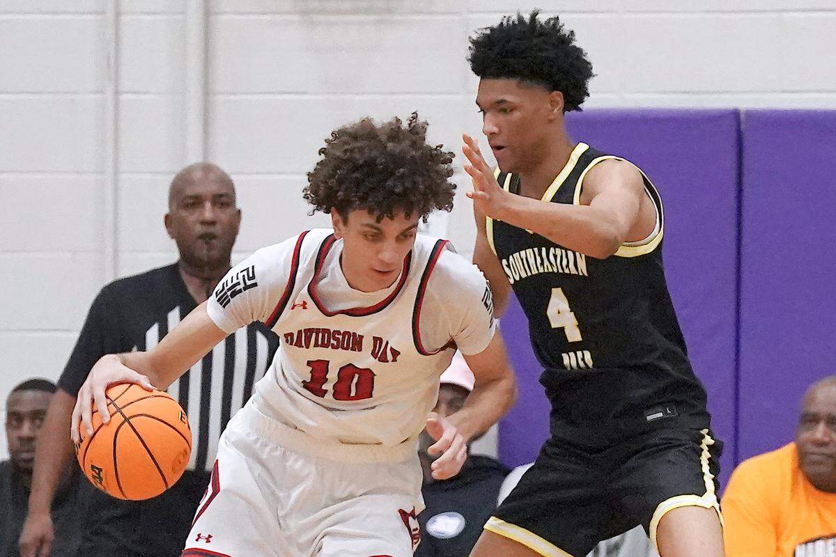 Davidson Day's Cody Peck (10) drives to the lane against Southeastern Prep's 	CJ Rosser Jr. (4) during the first half. The Davidson Day Patriots and the Southeastern Prep Academy National Falcons met in the John Wall Holiday Tournament in Raleigh, N.C. on December 27, 2025.
