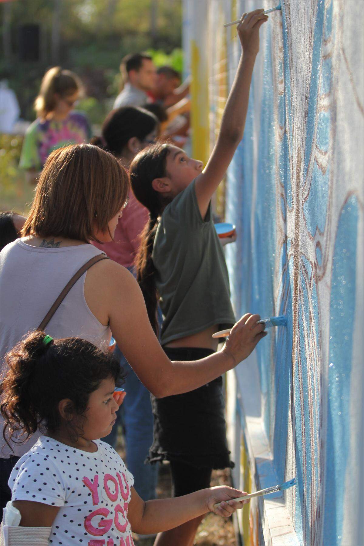 Painters work on a new Lakewood mural Saturday afternoon. The new mural will take over the entire wall of El Futuro, a mental health clinic serving Latino residents.