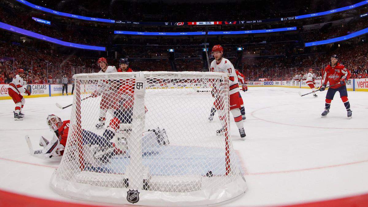 May 8, 2025; Washington, District of Columbia, USA; Carolina Hurricanes defenseman Shayne Gostisbehere (4) scores a goal on Washington Capitals goaltender Logan Thompson (48) in the third period in game two of the second round of the 2025 Stanley Cup Playoffs at Capital One Arena. Mandatory Credit: Geoff Burke-Imagn Images