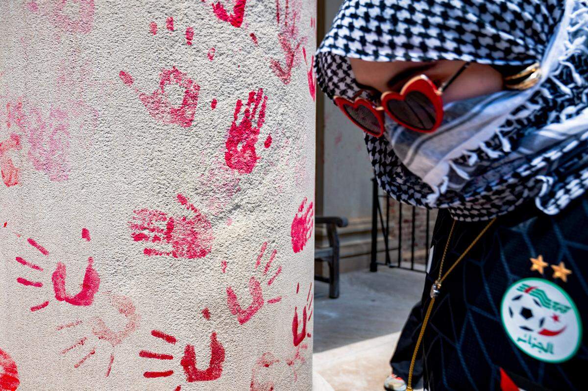 A pro-Palestine protester leaves their handprints on the pillars of South Building on Saturday, May 11, 2024.