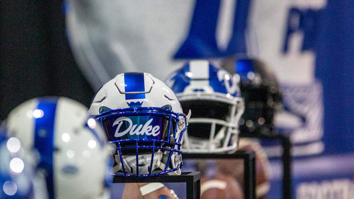 Footballs and helmets line the stage as Mike Elko is introduced as Duke’s head football coach during a press conference at Pascal Field House in Durham, Monday, Dec. 13, 2021.