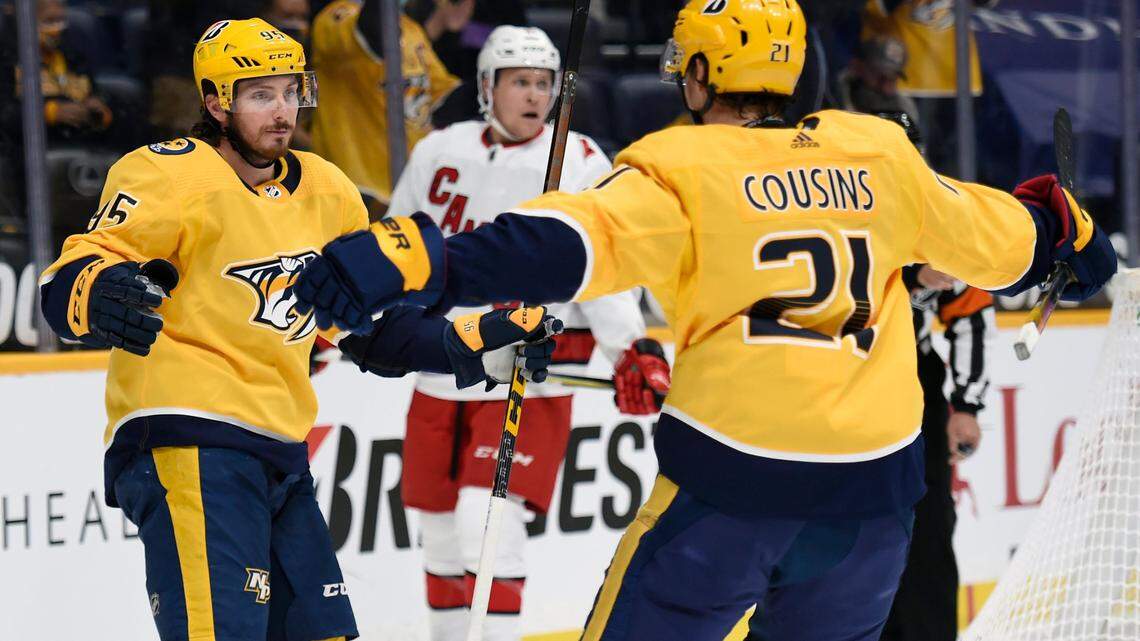 Nashville Predators center Matt Duchene (95) celebrates with Nick Cousins (21) after Duchene scored a goal against the Carolina Hurricanes during the second period of an NHL hockey game Monday, May 10, 2021, in Nashville, Tenn. (AP Photo/Mark Zaleski)