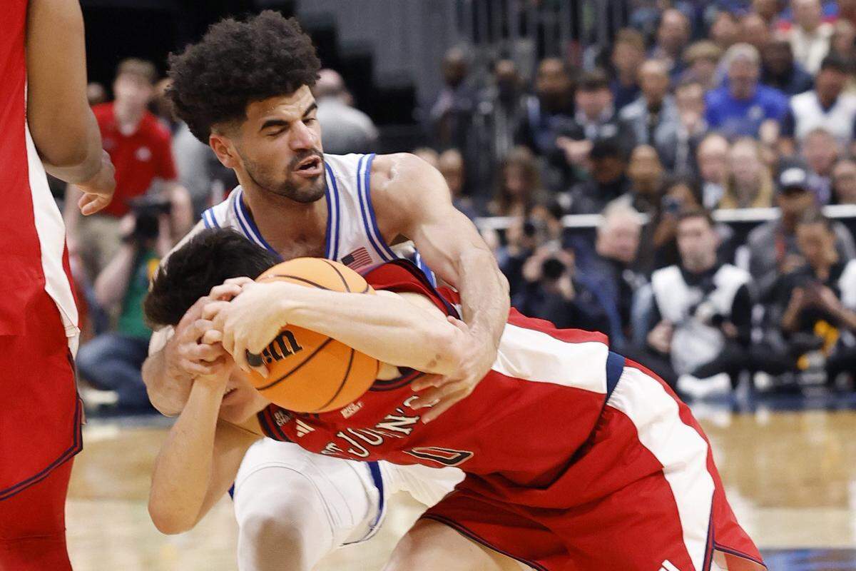 Duke’s Cayden Boozer (2) fouls St. John's Dylan Darling (0) during the first half of Duke’s game against St. John’s in the Sweet 16 of the NCAA Men’s Basketball East Regional at Capital One Arena in Washington, D.C., Friday, March 27, 2026.