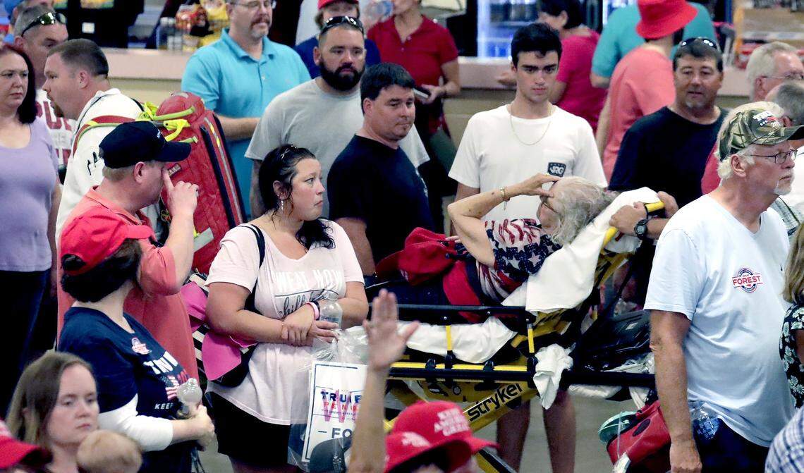 Medical personnel tend to a person who collapsed while President Donald Trump and Congressional candidate Dan Bishop were speaking at a rally in Fayetteville, N.C., Monday, Sept. 9, 2019.