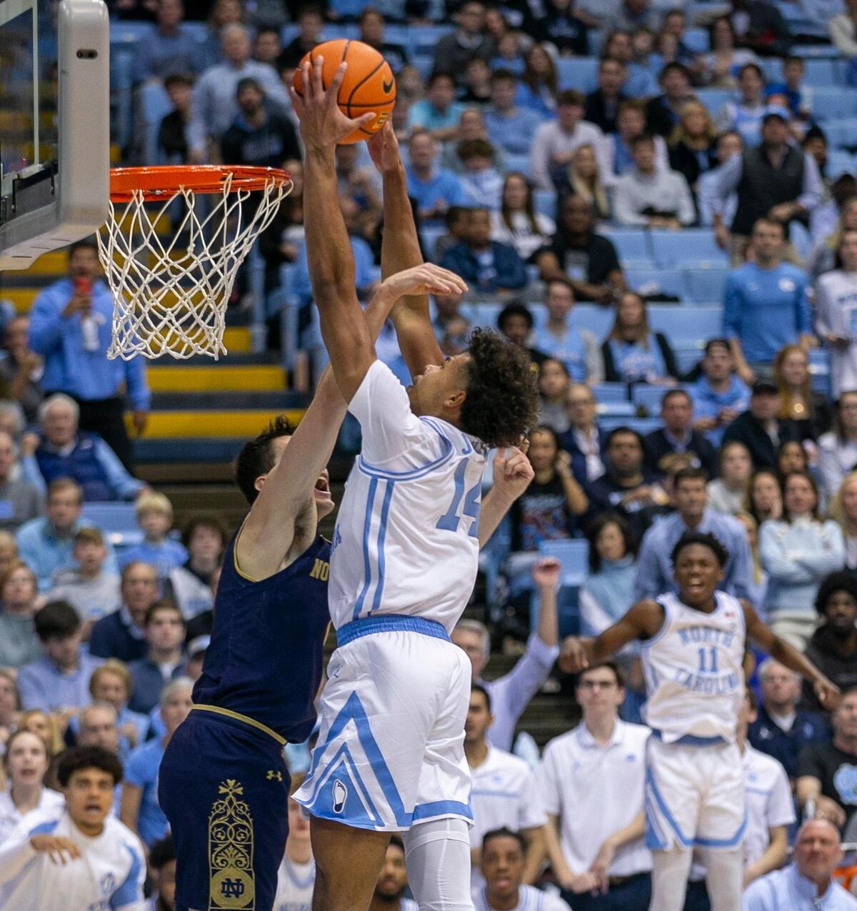 North Carolina’s Puff Johnson (14) dunks against Notre Dame’s Cormac Ryan (5) during the second half on Saturday, January 7, 2023 at the Smith Center in Chapel Hill, N.C.