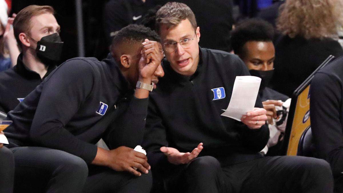 Duke associate head coach Jon Scheyer talks with assistant coach Nolan Smith during Duke’s 76-64 victory over Wake Forest at LJVM Coliseum in Winston-Salem, N.C., Wednesday, January 12, 2022.