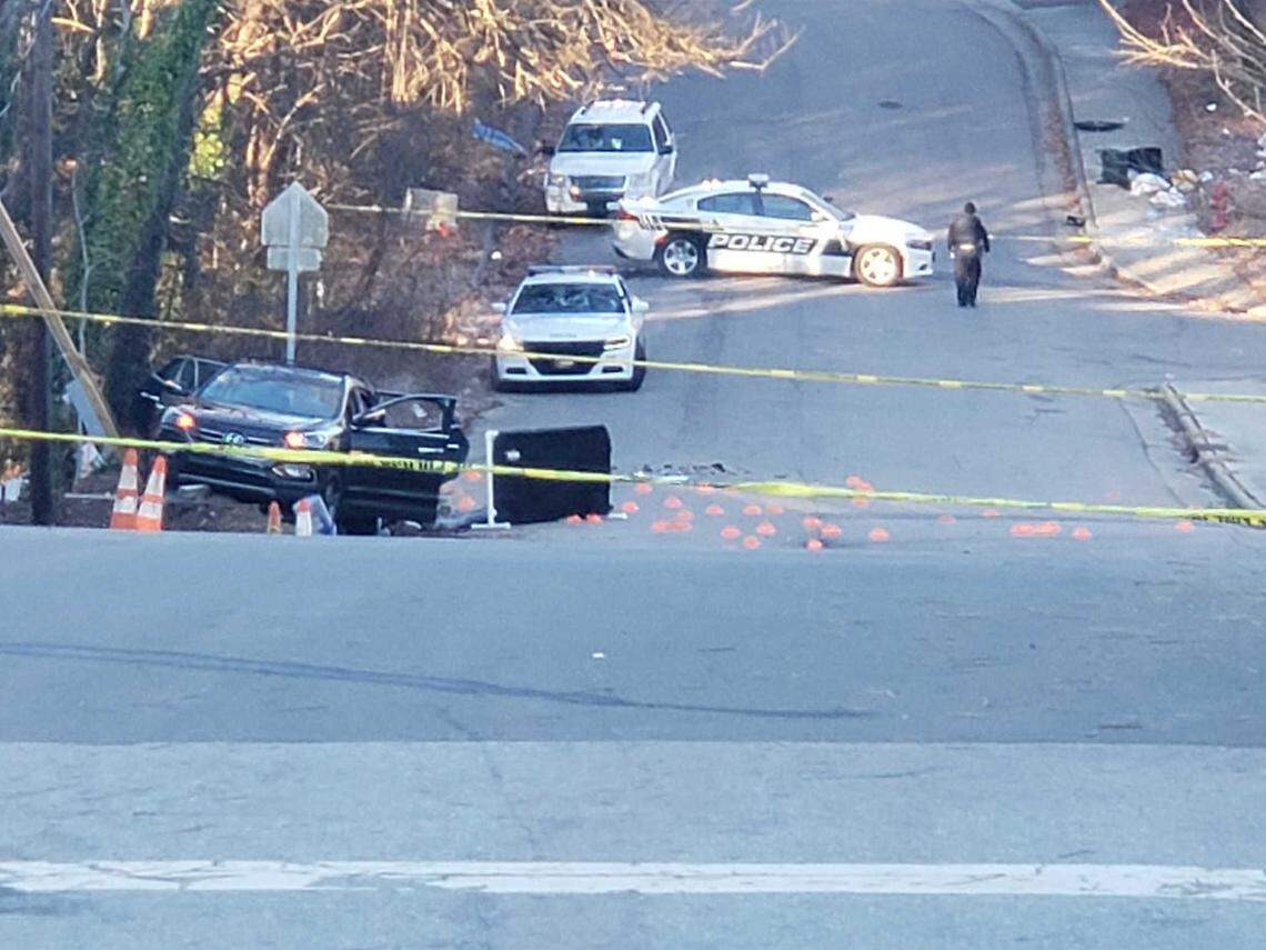As of 8 a.m. Monday, the vehicle, with its flashers blinking, remained crashed on the side of the road where Durham police found six young people shot. Dozens of red evidence markers were scattered across the ground.